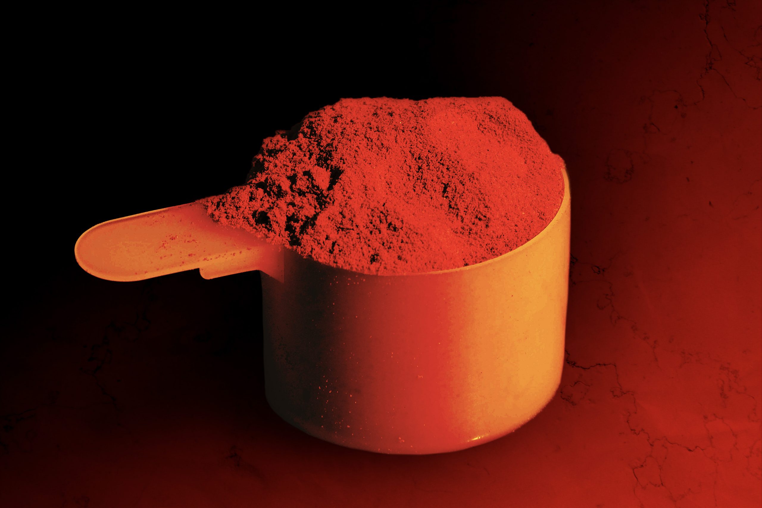 Photo illustration of dry-scooping powder as a health and diet supplement