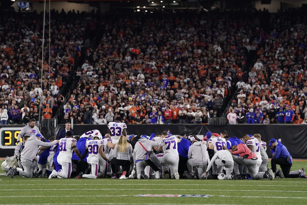 Buffalo Bills players huddle and pray after teammate Damar Hamlin #3 collapsed on the field after making a tackle against the Cincinnati Bengals during the first quarter at Paycor Stadium on January 02, 2023 in Cincinnati, Ohio