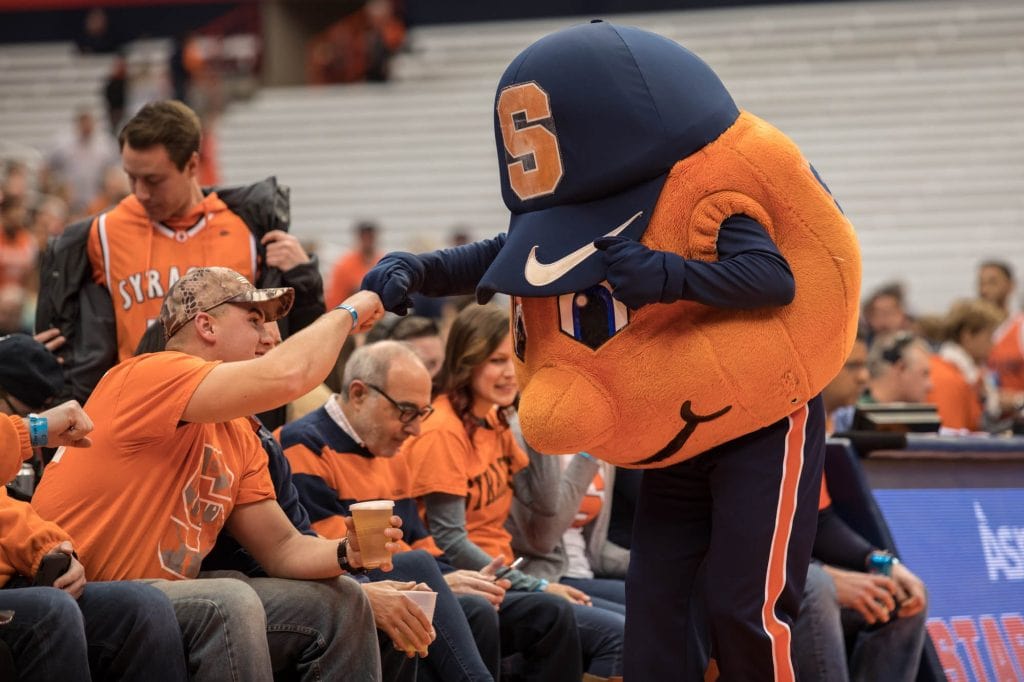 Otto the Orange fist bumps a fan