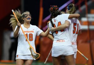 Syracuse Women's Lacrosse's Meghan Tyrrell (18), Mary Rahal (44) and Emily Hawryschuk (51) celebrate a goal at the Carrier Dome in Syracuse, NY on March 2, 2018. Syracuse won the matchup against University of Virginia 16 to 11.