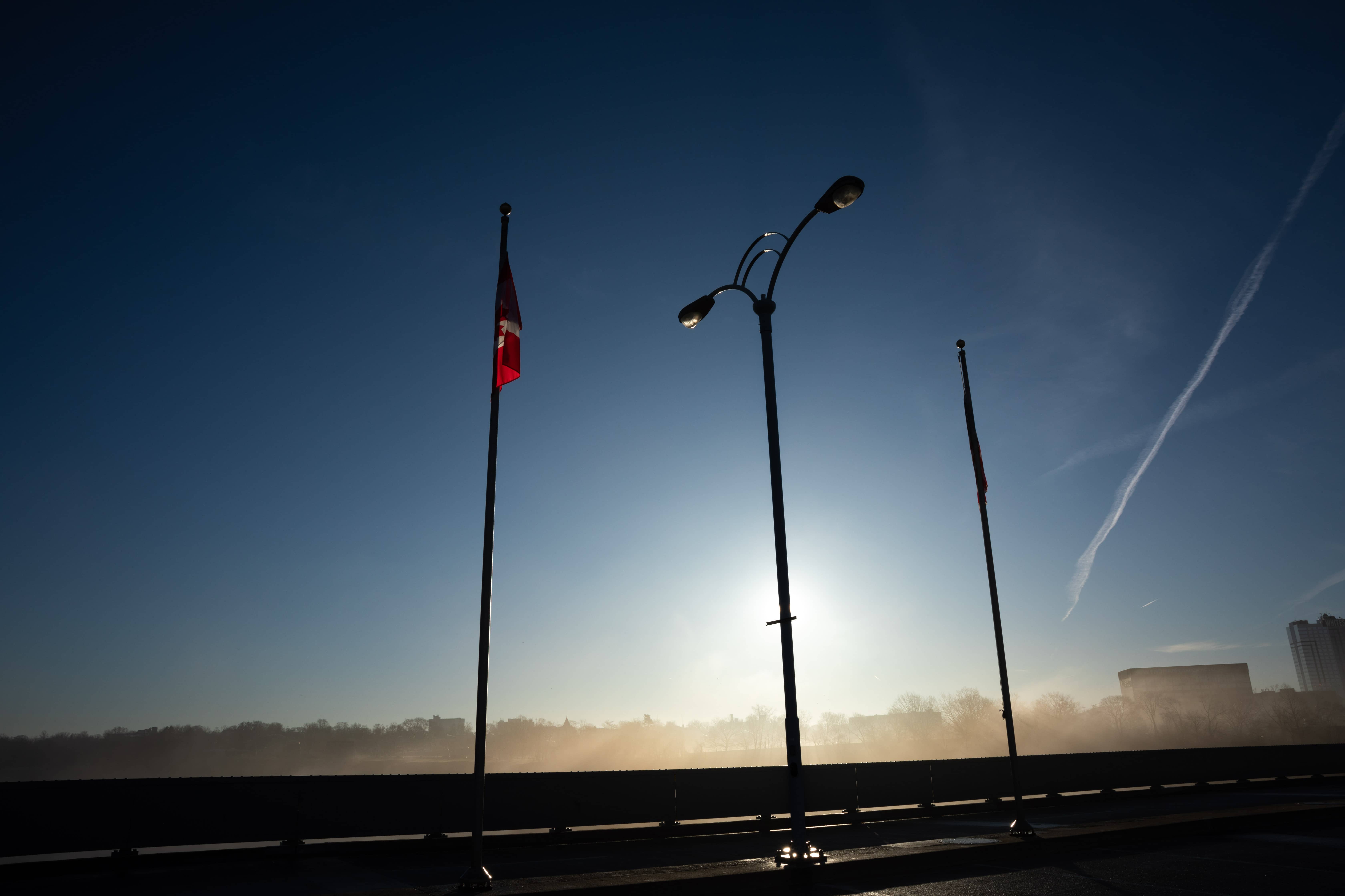 Looking northeast on Rainbow International Bridge. The Canadian Flag is on the left and the American flag is to the right.