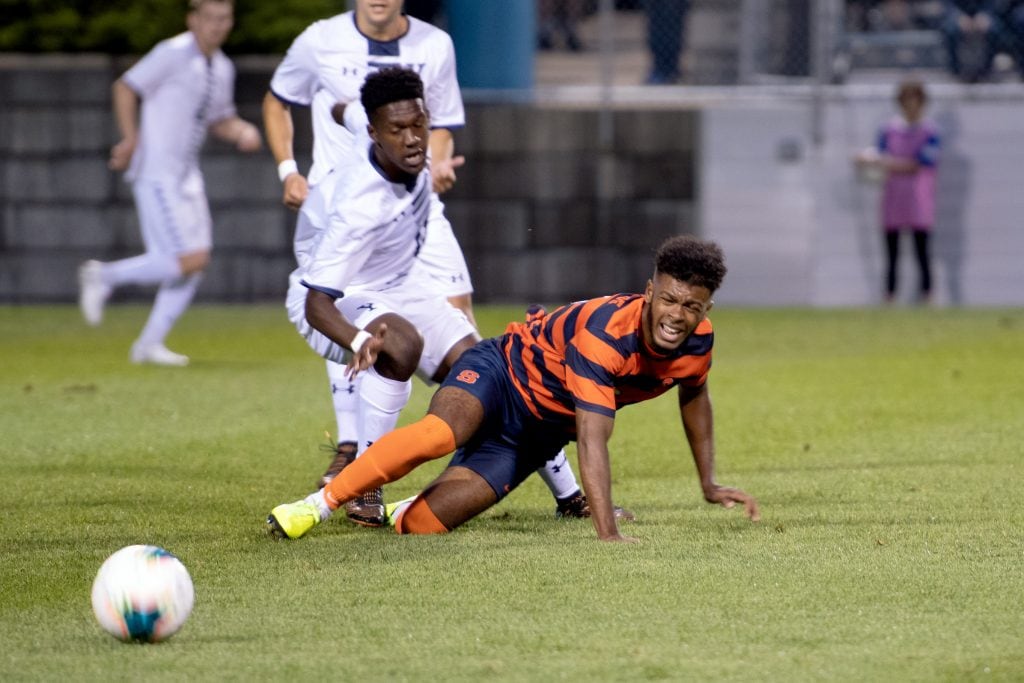 Julio Fulcar falls to the ground going after after a ball against Yale on Friday.