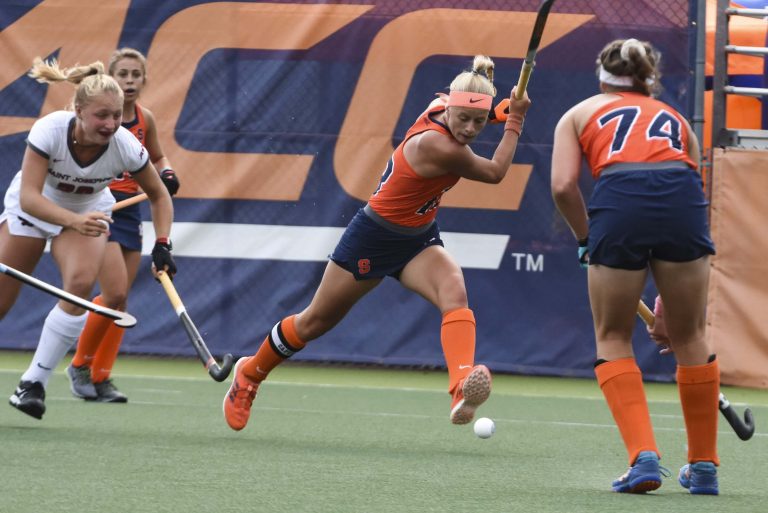 Charlotte De Vries sends the ball across the field for a Syracuse Field Hockey gain.