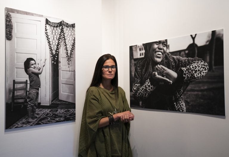 Maranie Staab, photographer, stands in her exhibit in Art Rage gallery in Syracuse, NY.
