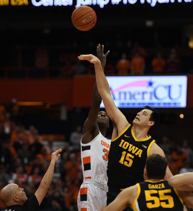 SU’s Bourama Sidibe and Iowa’s Ryan Kriener jump for the opening tipoff during the ACC/Big Ten Challenge at the Carrier Dome on December 3, 2019.