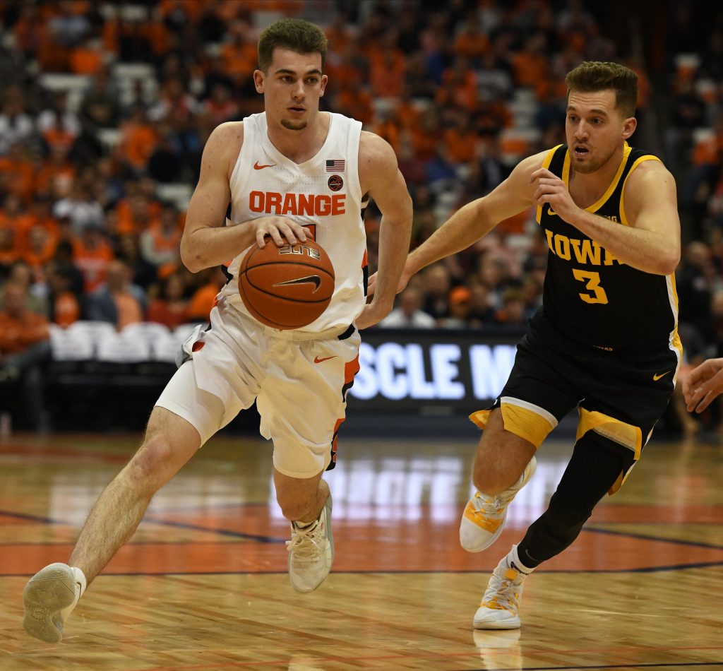 Joseph Girard III drives with the basketball as Jordan Bohannon defends during the ACC/Big Ten Challenge at the Carrier Dome on December 3, 2019.