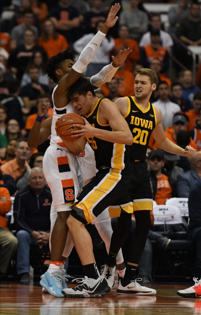Iowa’s Luka Garza drives to the basket as Quincy Guerrier defends during the ACC/Big Ten Challenge at the Carrier Dome on December 3, 2019.