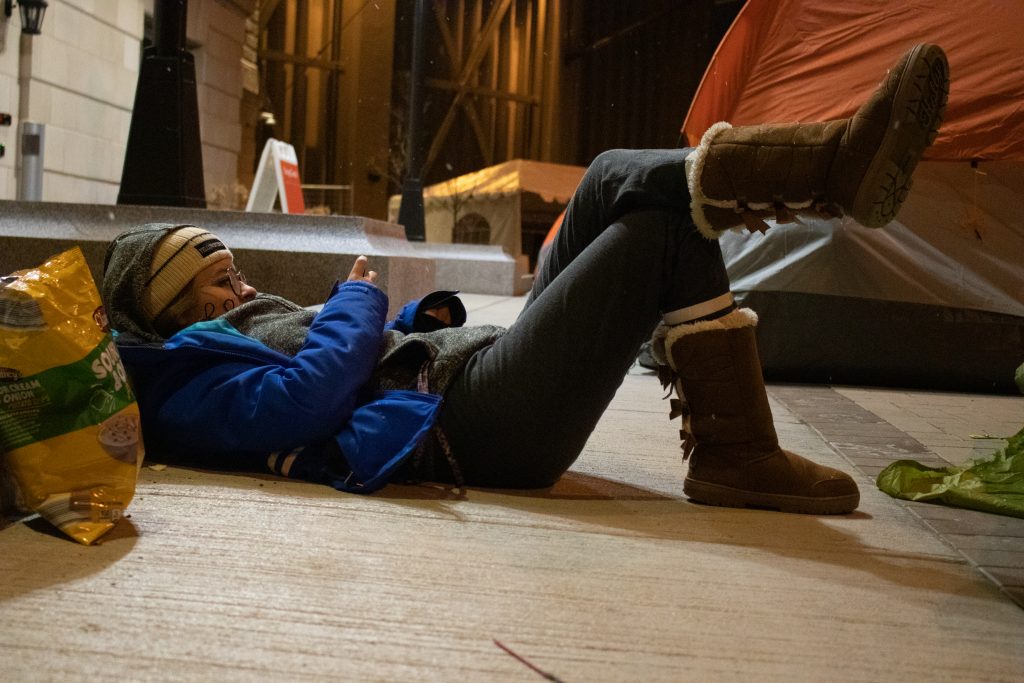 Sophomore Lydia Engel relaxes outside her tent during the Syracuse Men's Basketball vs. Duke Pregame Basketball event on the night of January 31, 2020.