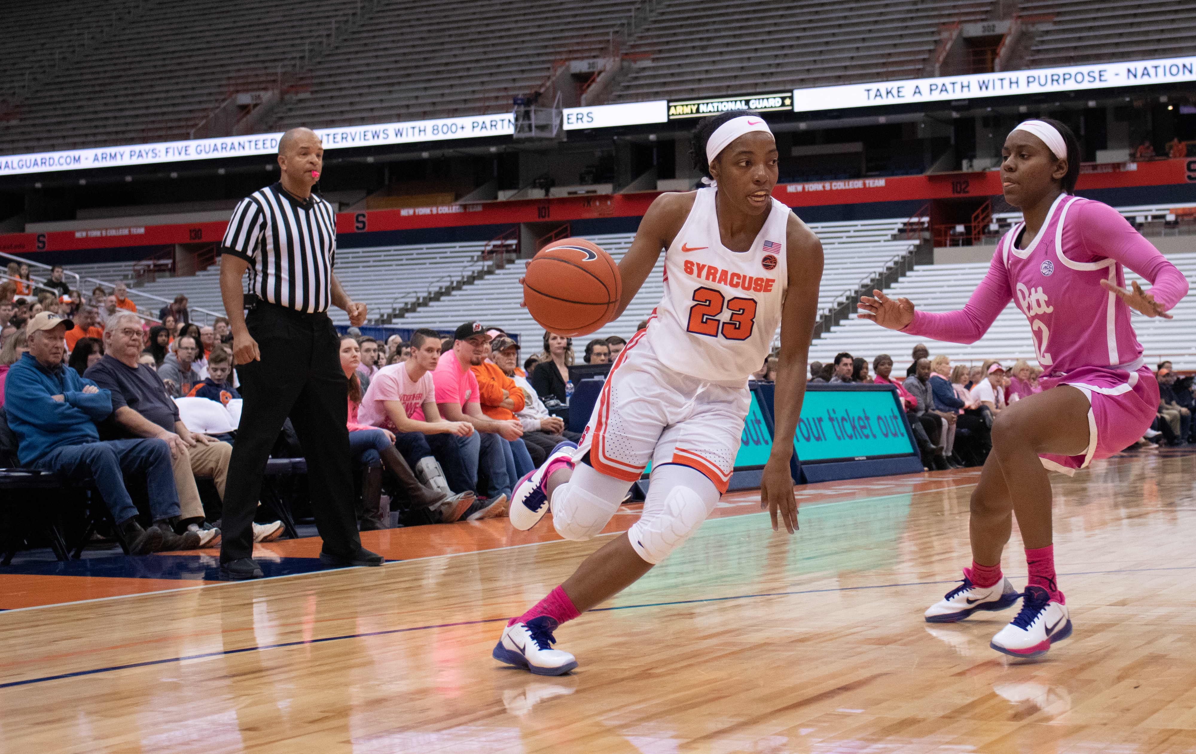 Syracuse University's guard, Kiara Lewis, 23, pushes past a University of Pittsburgh defender during a college basketball game on February 16, 2020.