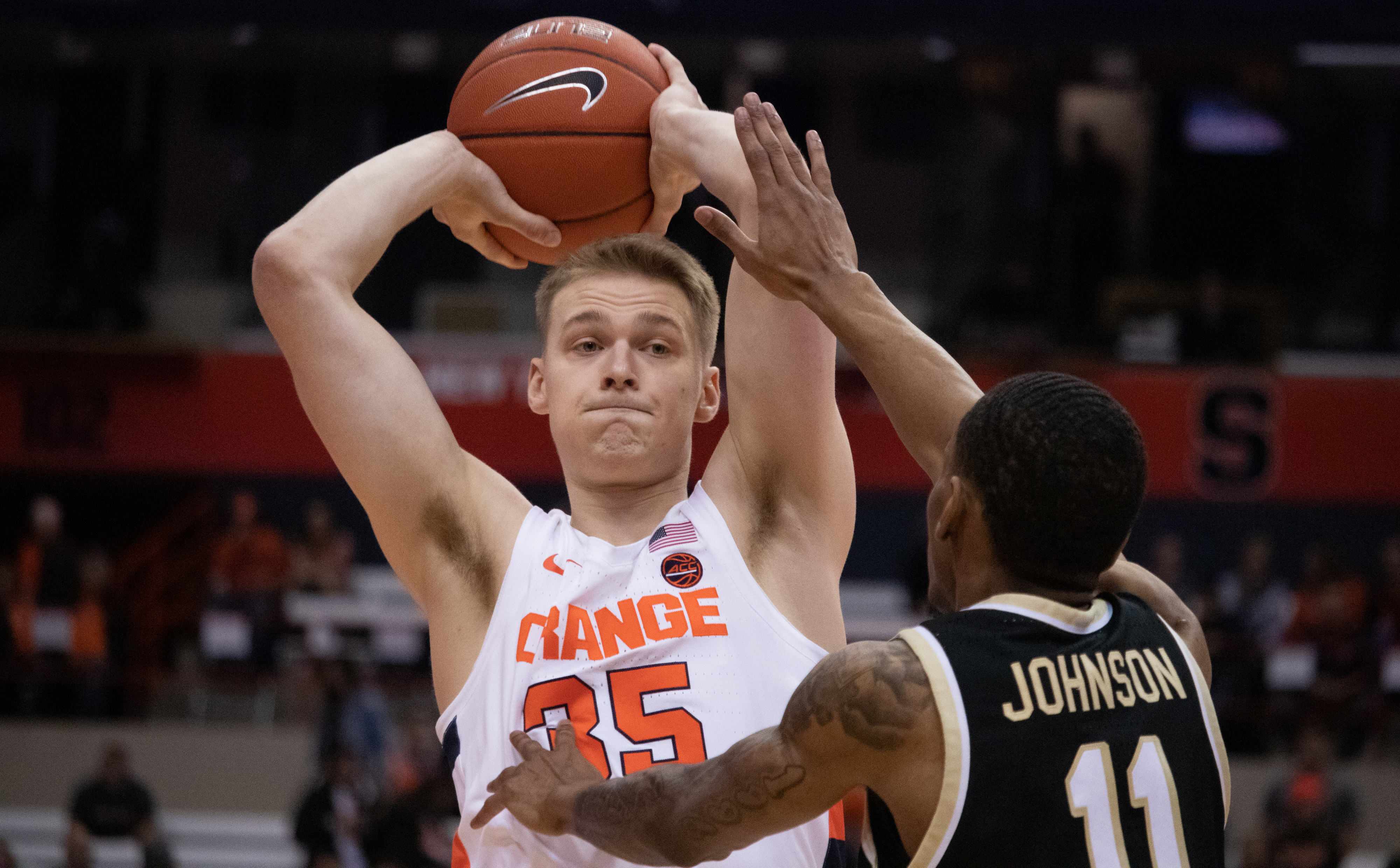 Syracuse guard, Buddy Boeheim, 35, gets ready to pass the ball to his teammates as Wake Forest guard Torry Johnson, 11, tries to block his pass during the first half of a college basketball game on February 8, 2020.