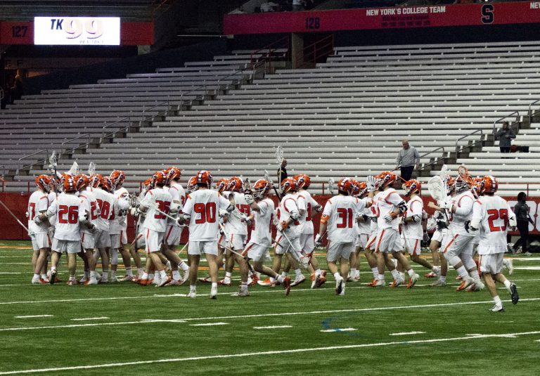 The Syracuse men's lacrosse team celebrates after winning their home opener versus Colgate 21-6 in the Carrier Dome.