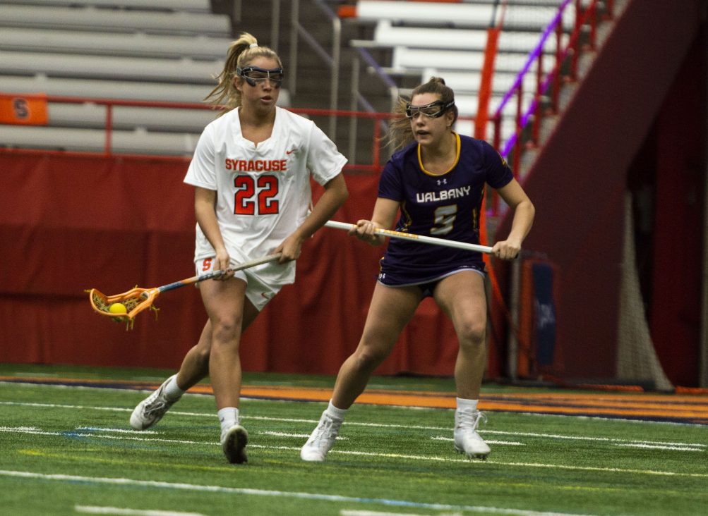 Megan Carney looks to a teammate as Albany's Kyla Zapolski defends during Saturday's game in the Carrier Dome.