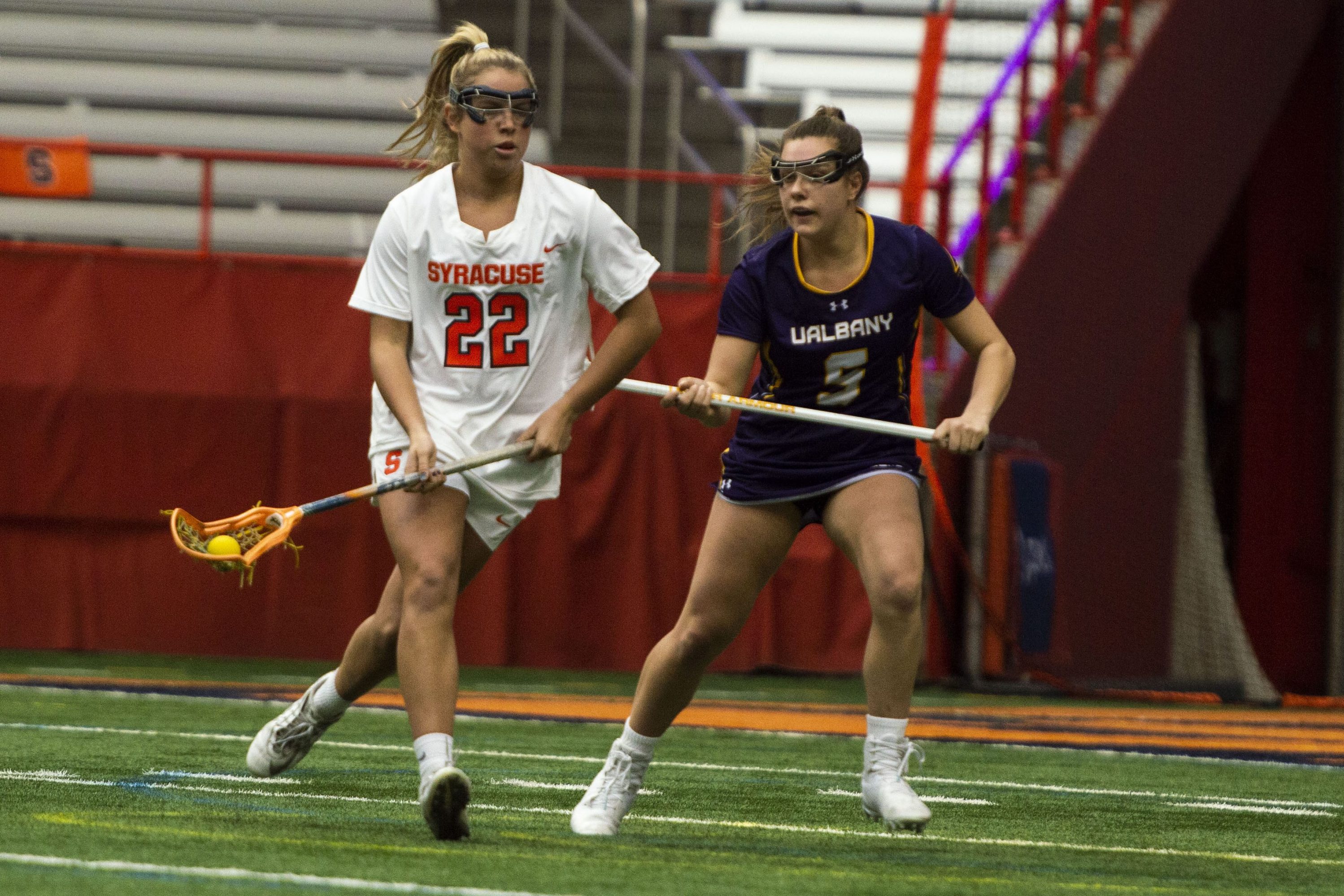 Megan Carney looks to a teammate as Albany's Kyla Zapolski defends during Saturday's game in the Carrier Dome.