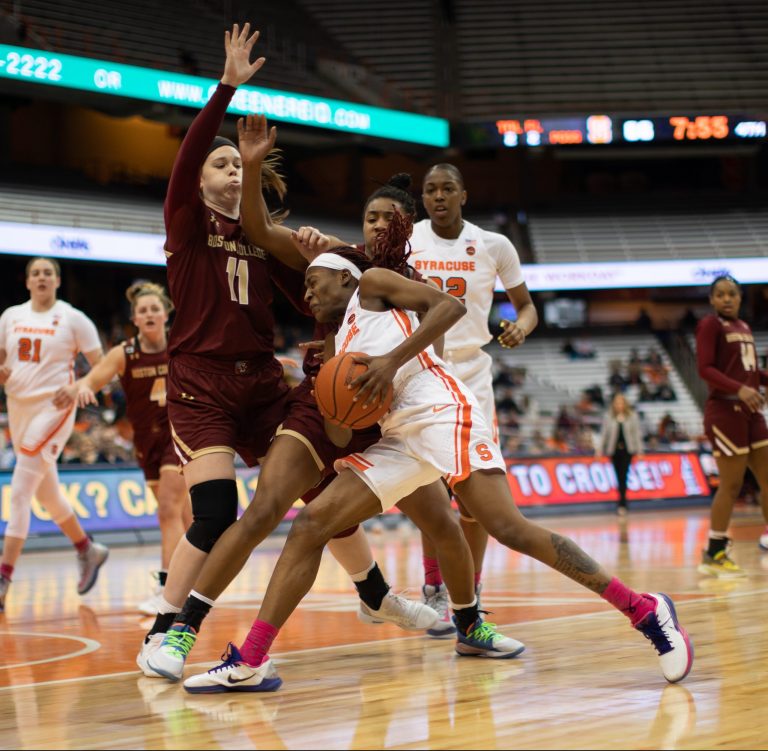 Gabrielle Cooper dives into defense as she goes in for a lay up against Boston College's Emma Guy defends.