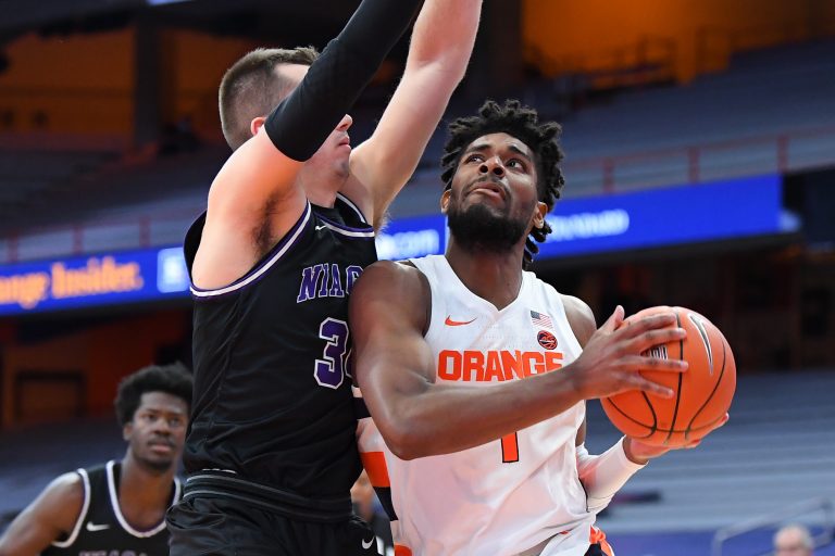 Syracuse Orange forward Quincy Guerrier (1) drives to the basket against the defense of Niagara