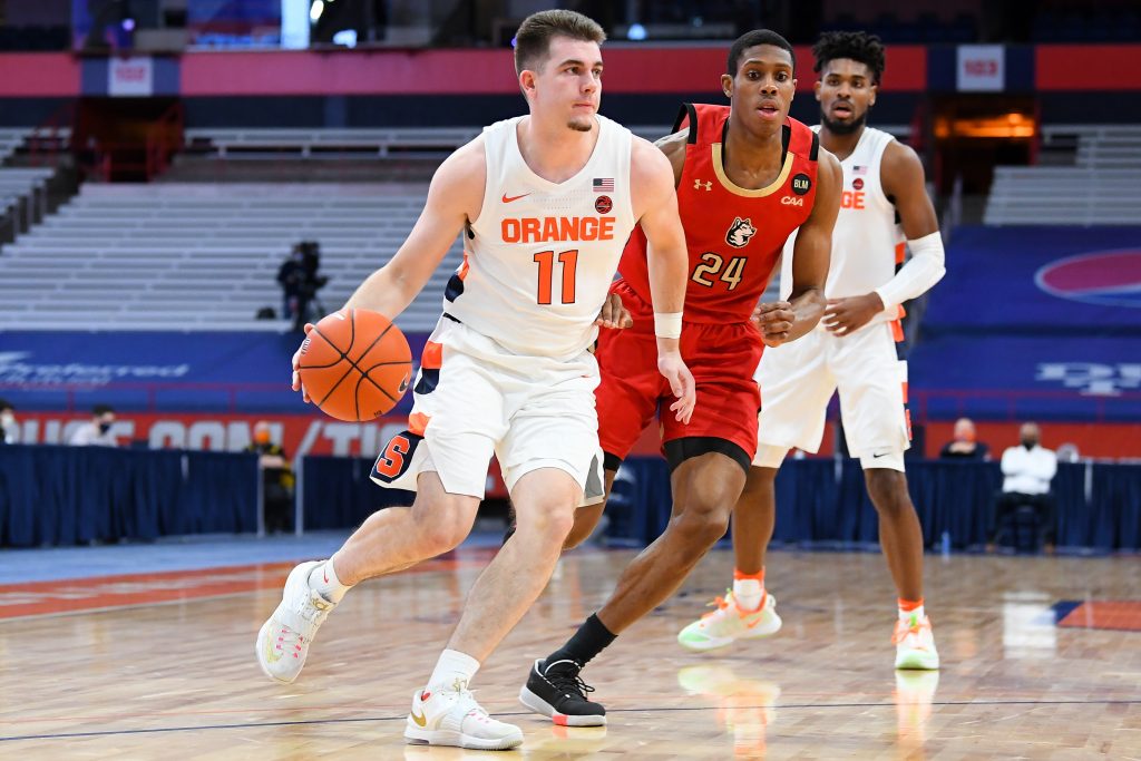 Dec 16, 2020; Syracuse, New York, USA; Syracuse Orange guard Joseph Girard III (11) drives to the basket past Northeastern Huskies guard Shaquille Walters (24) during the first half at the Carrier Dome. Mandatory Credit: Rich Barnes-USA TODAY Sports