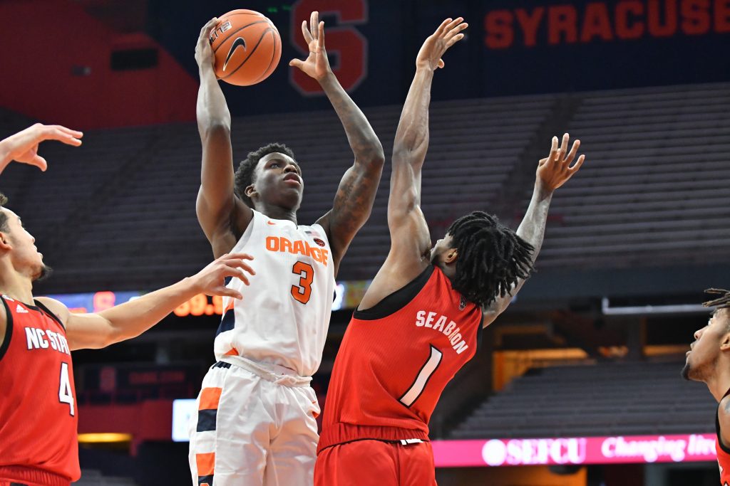 Jan 31, 2021; Syracuse, New York, USA; Syracuse Orange forward Kadary Richmond (3) shoots the ball as North Carolina State Wolfpack guard Dereon Seabron (1) defends in the first half at the Carrier Dome. Mandatory Credit: Mark Konezny-USA TODAY Sports