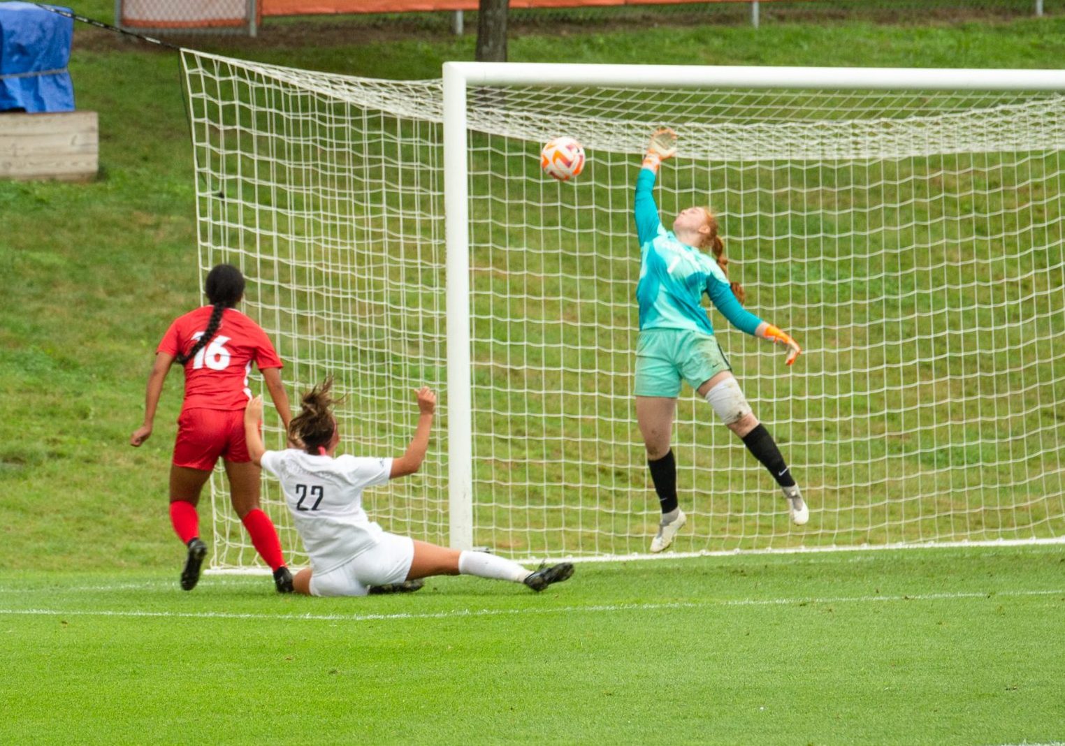 Syracuse University player scores on Cornell goalie