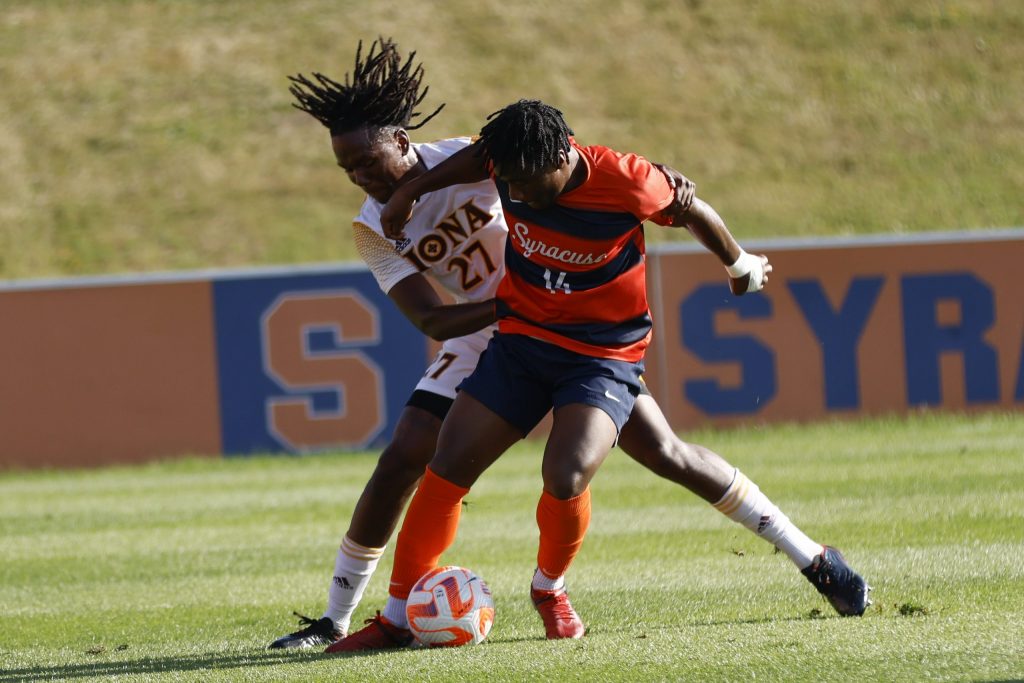 Syracuse forward Levonte Johnson tries to outmaneuver an Iona defender on Aug. 25, 2022.