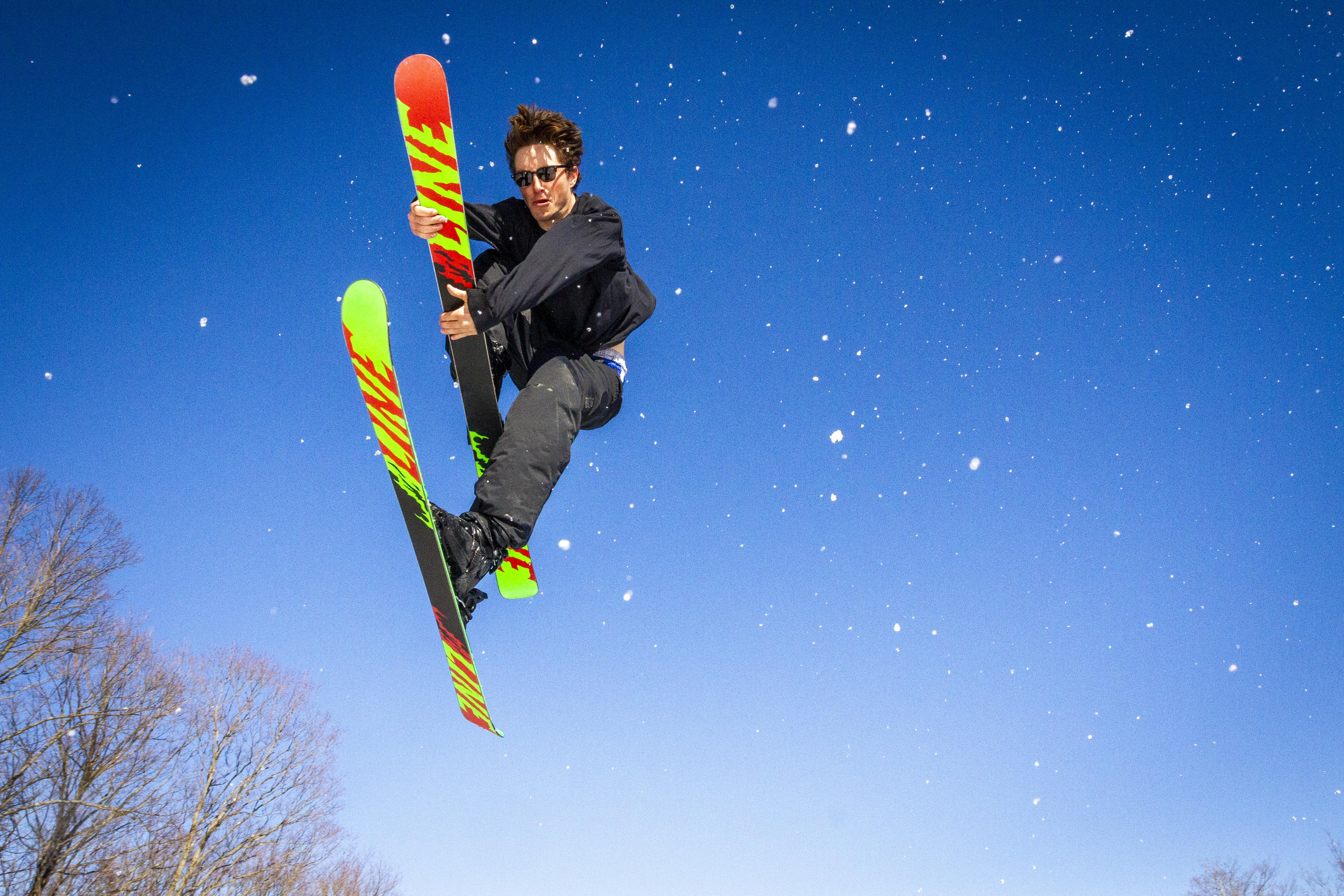Mikey MacKnight grabs his ski as he airs of the last jump at Labrador Mountain in Truxon, New York. Mikey grew up skiing in the Syracuse, New York area and is one of the better local riders.