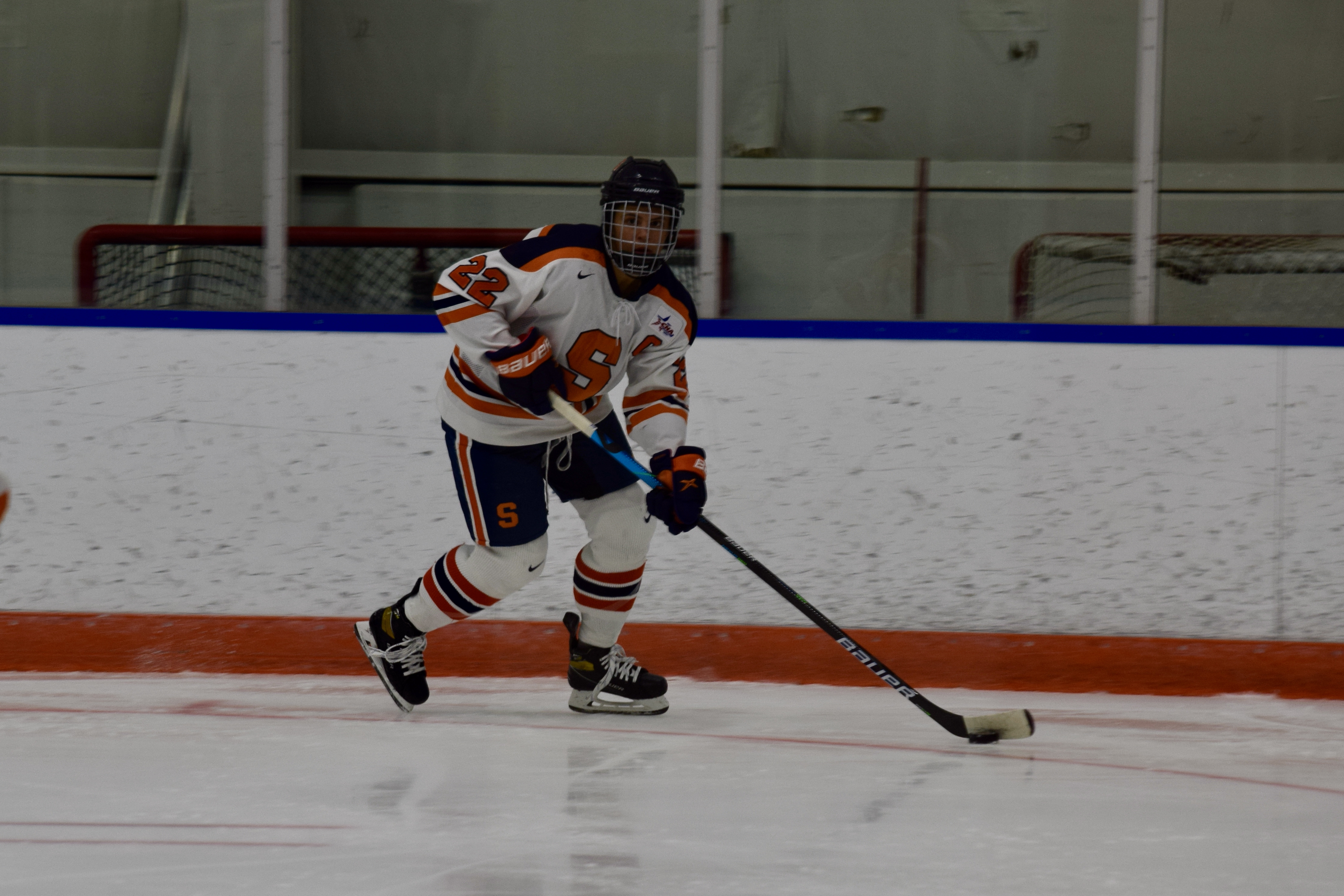 Syracuse women's ice hockey Jessica DiGirolamo keeps the puck away from defenders during a game against Penn State on Dec. 11, 2020 at Tennity Ice Pavillion