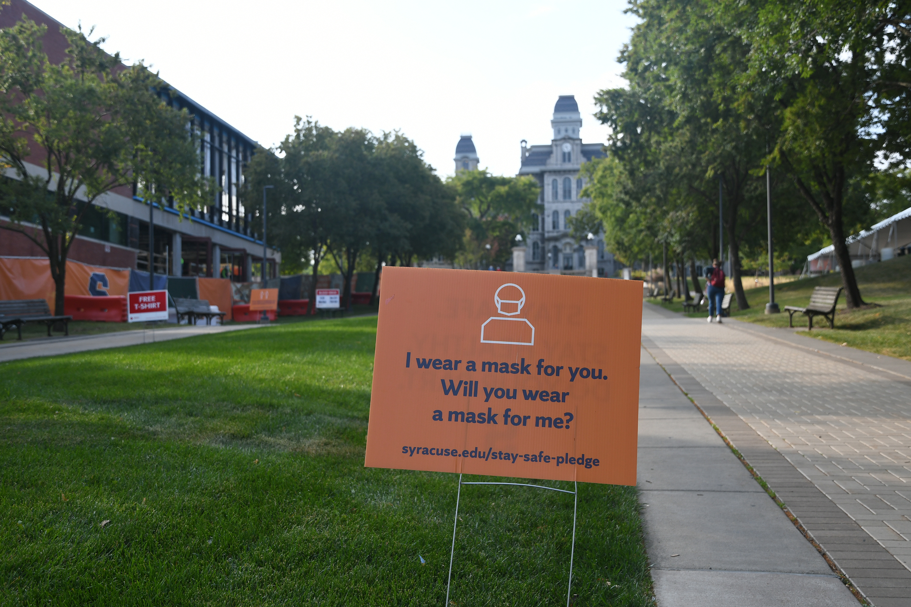 Signs reminding students to wear a mask on campus can be found around Syracuse University.