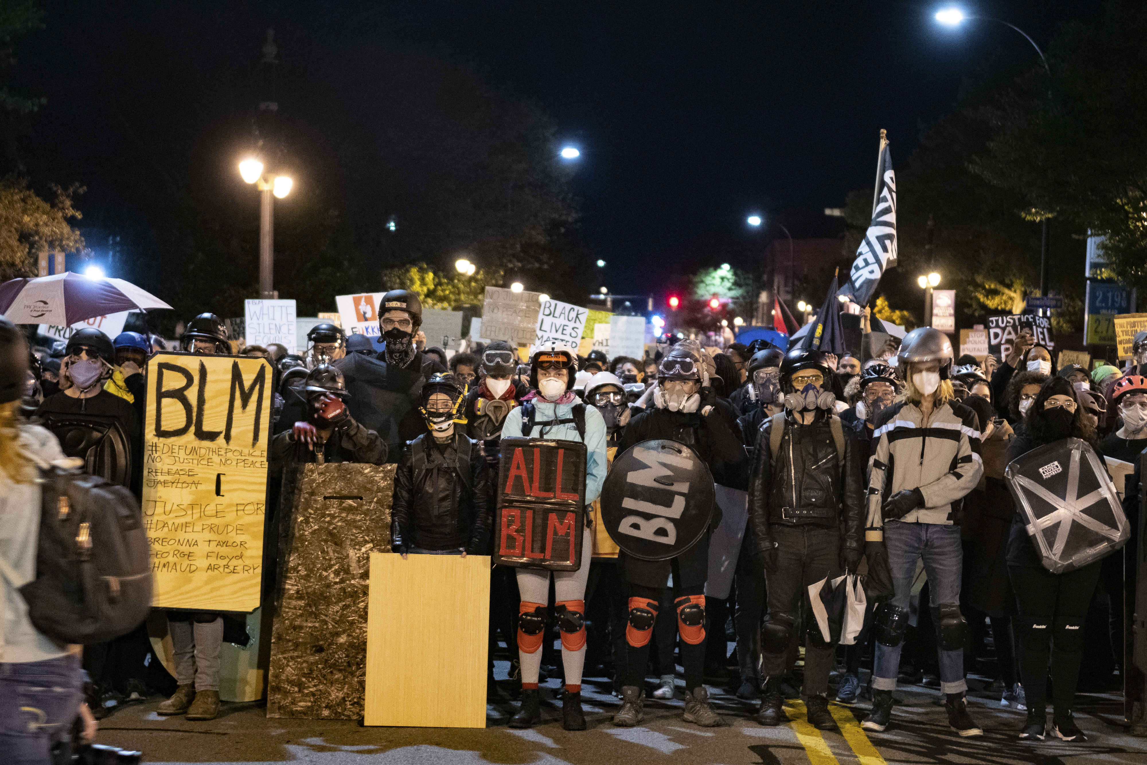 Protesters form a wall as they march to Exchange Boulevard. Demonstrators were equipped with homemade shields, goggles and masks in preparation.