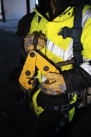 Allen holds a beam clamp used to help place iron beams.