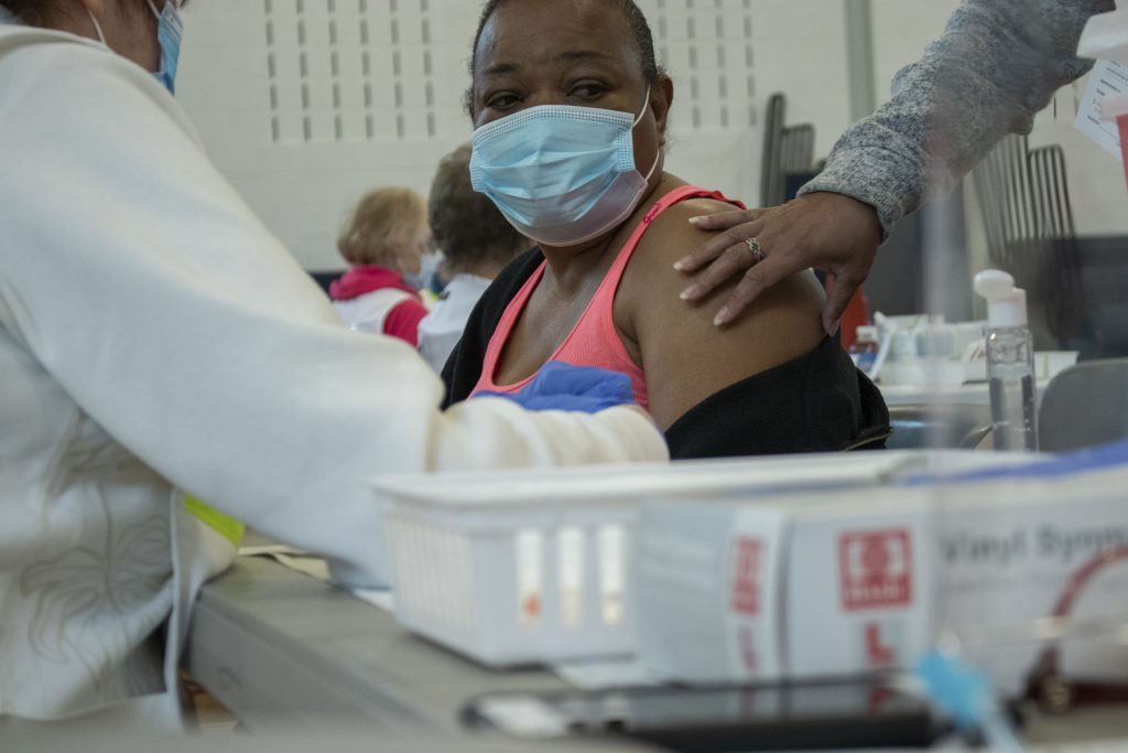 Virginia Piazz arrives at the vaccine clinic with her daughter and husband to get their vaccines. Neither Virginia nor her husband speaks much English, so their daughter translates for them.