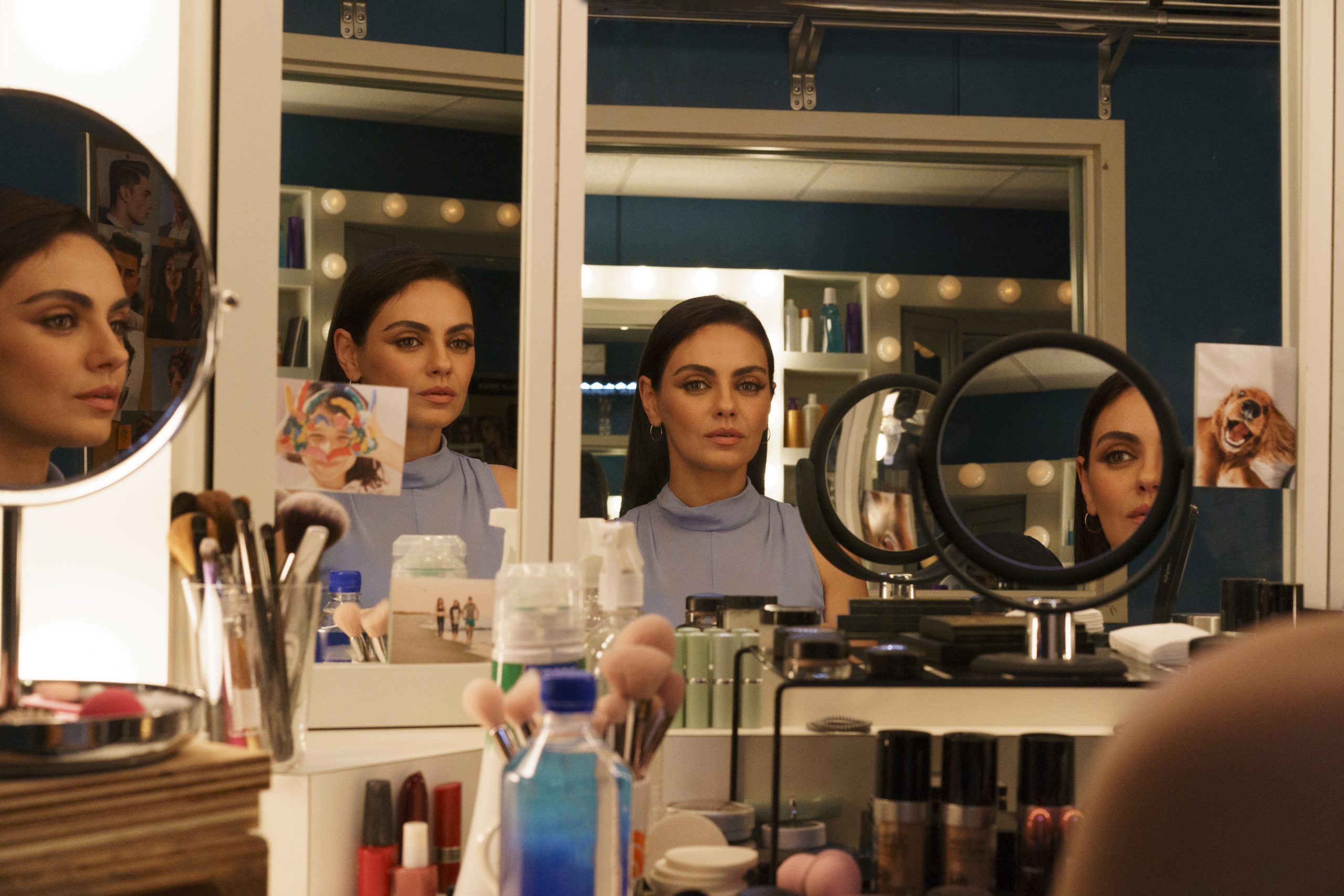 Mila Kunis in Luckiest Girl Alive stares at herself through several mirrors on her vanity.