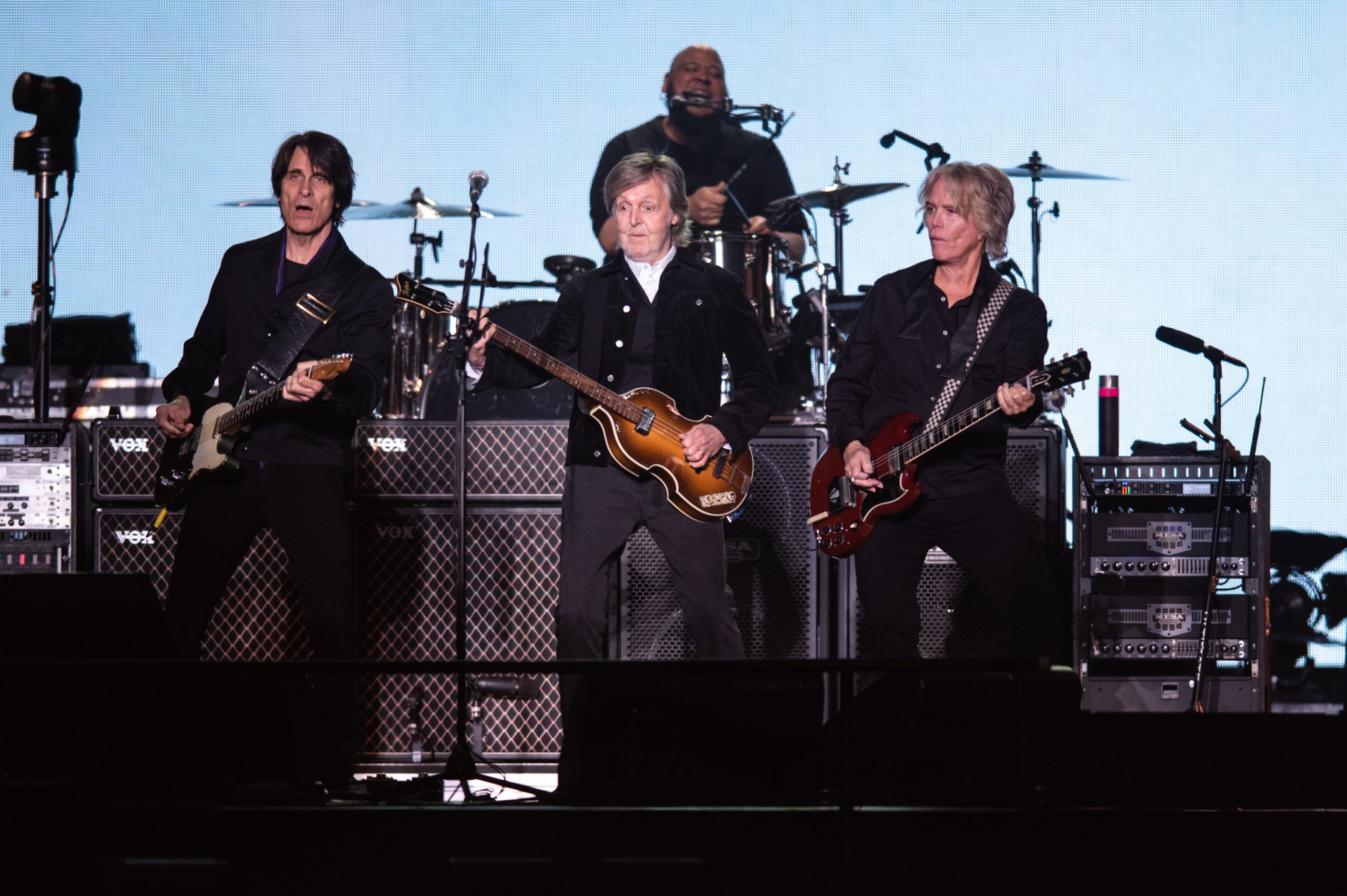 Paul McCartney, flanked by guitarists Rusty Anderson, left, and Brian Ray, performs at the JMA Wireless Dome in Syracuse, NY on June 4, 2022. McCartney played in Syracuse as part of a 13-city North American tour.