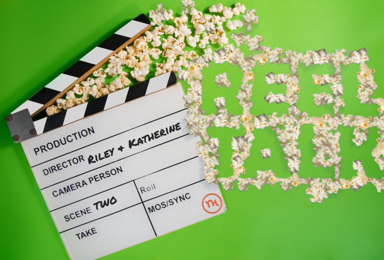 Popcorn spells out "Reel Talk" next to a film clapper.