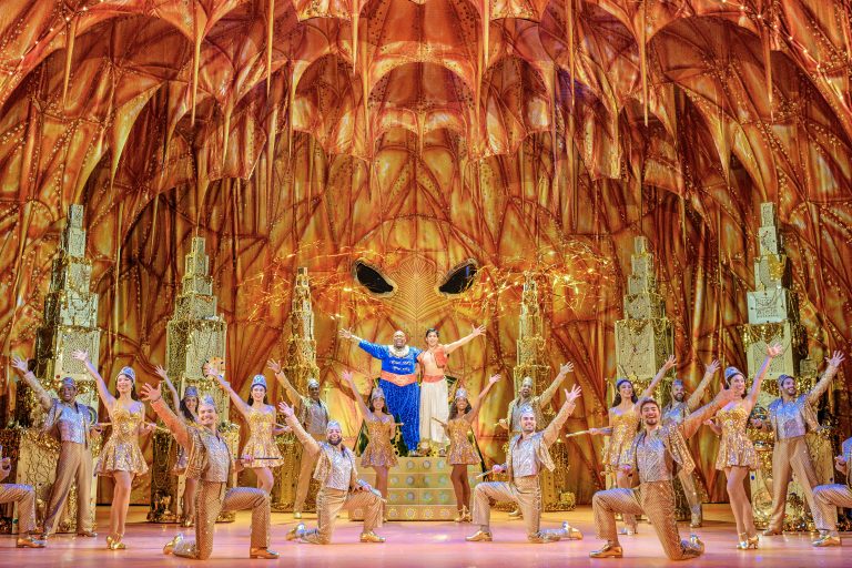 Marcus M. Martin (Genie) and Adi Roy (Aladdin) and dancers in the touring production of "Aladdin."