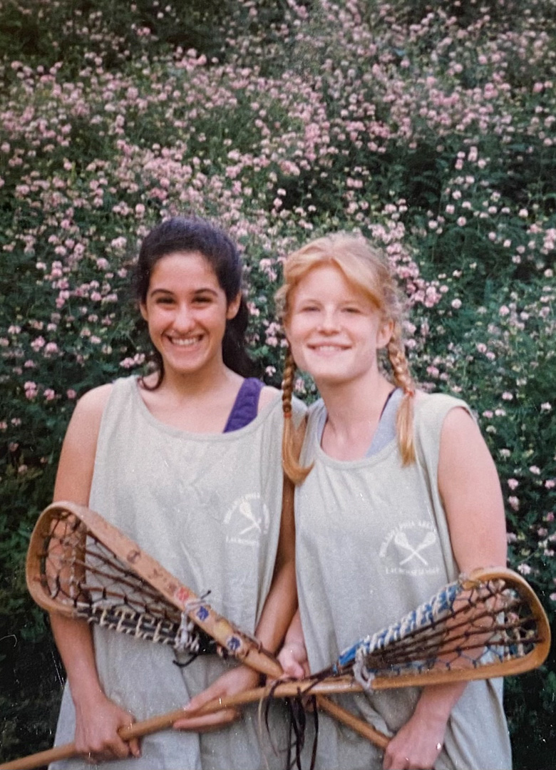 Alexis Snader Braunfeld (left) and Maggy Hiltner (right) pose with their lacrosse sticks.