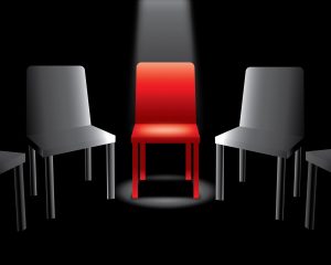 Illustration of chairs in a circle with a light beaming down on a red on in the center of the image