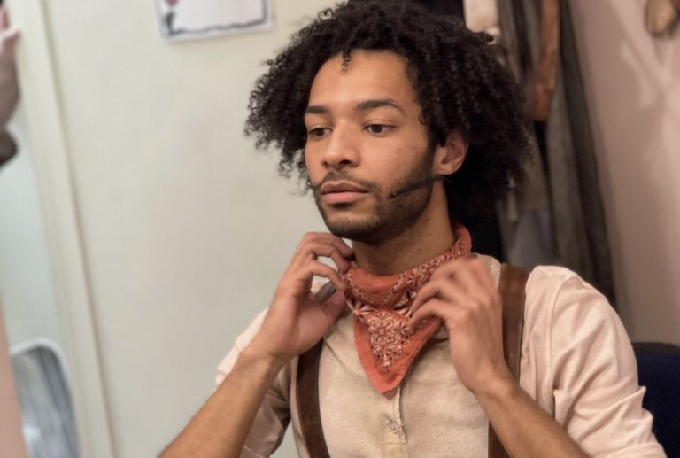 Actor Jordan Dobson gets ready backstage for his role as Orpheus