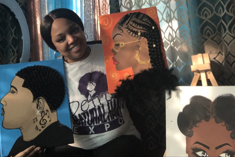 Hairdresser and artist Tiffany Moore posing with some of the paintings she has created