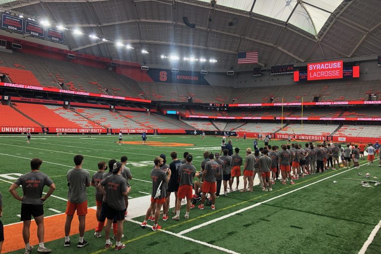 The 2022 Syracuse men's lacrosse team watches Orange alumni play in a friendly game on Saturday in the Dome.