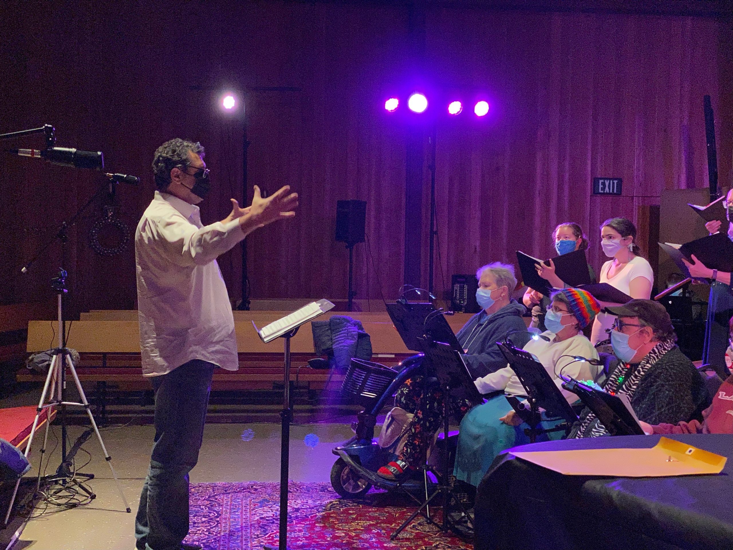 Director Stephen Gamba leads the chorus through rehearsal
