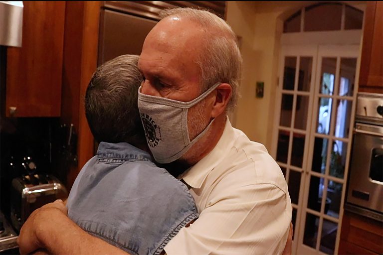 Michele Miller and Jeff Miller' embrace in their Arizona home in fall 2020 as Michele is in remission from ovarian cancer.