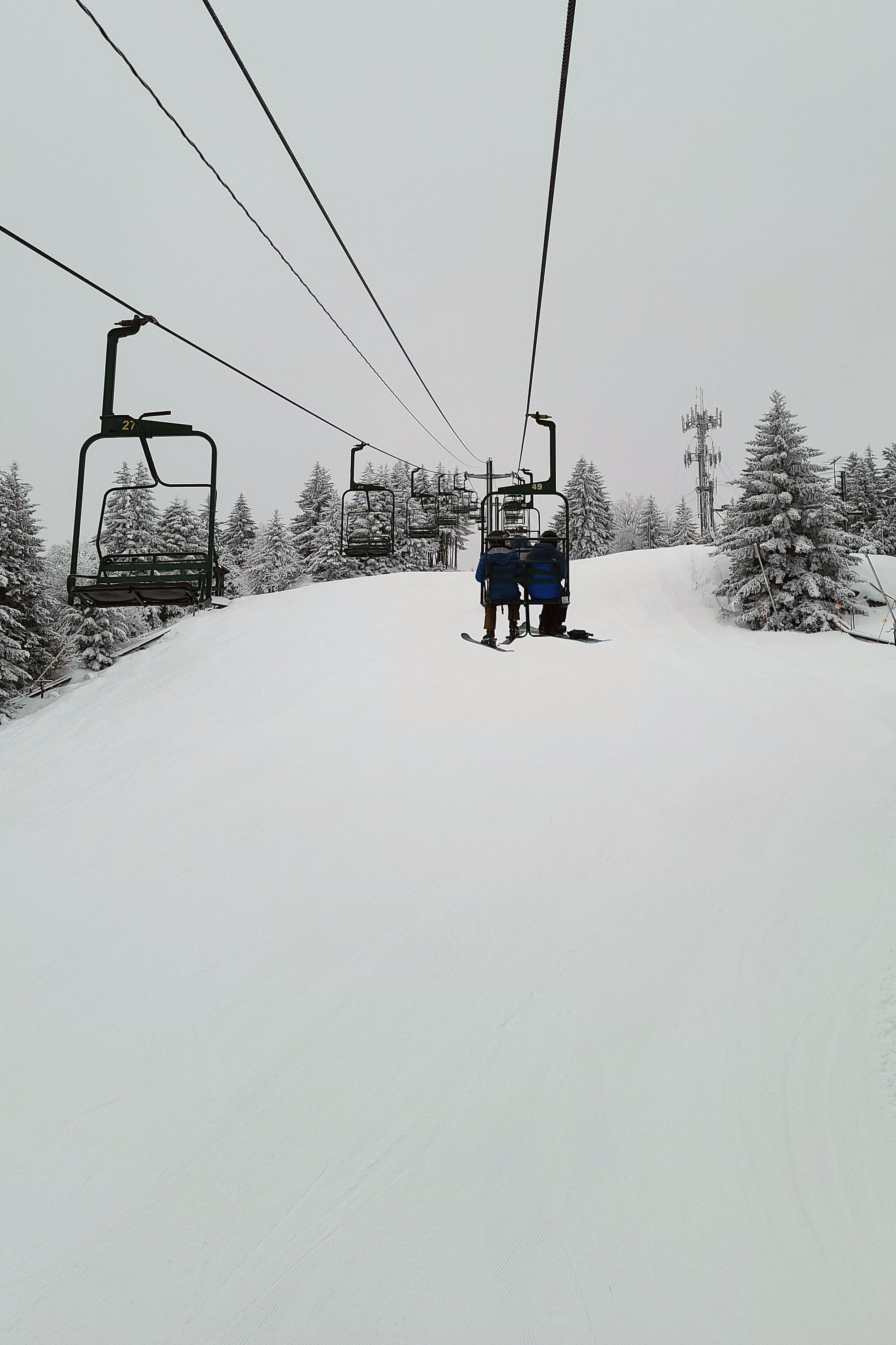 Skiers take the chairlift up McCauley Mountain.