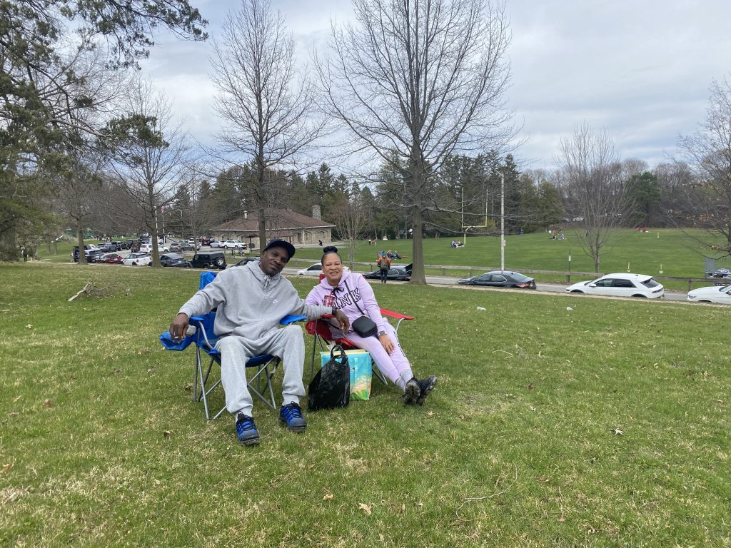 Joe and Telisha Stafford sit in folding chairs at Thornden Park, Syracuse preparing for the total solar eclipse Monday April 8th.