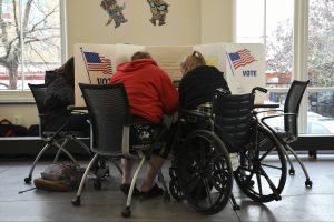 A voter with disablity receives accommodation in the voting process.