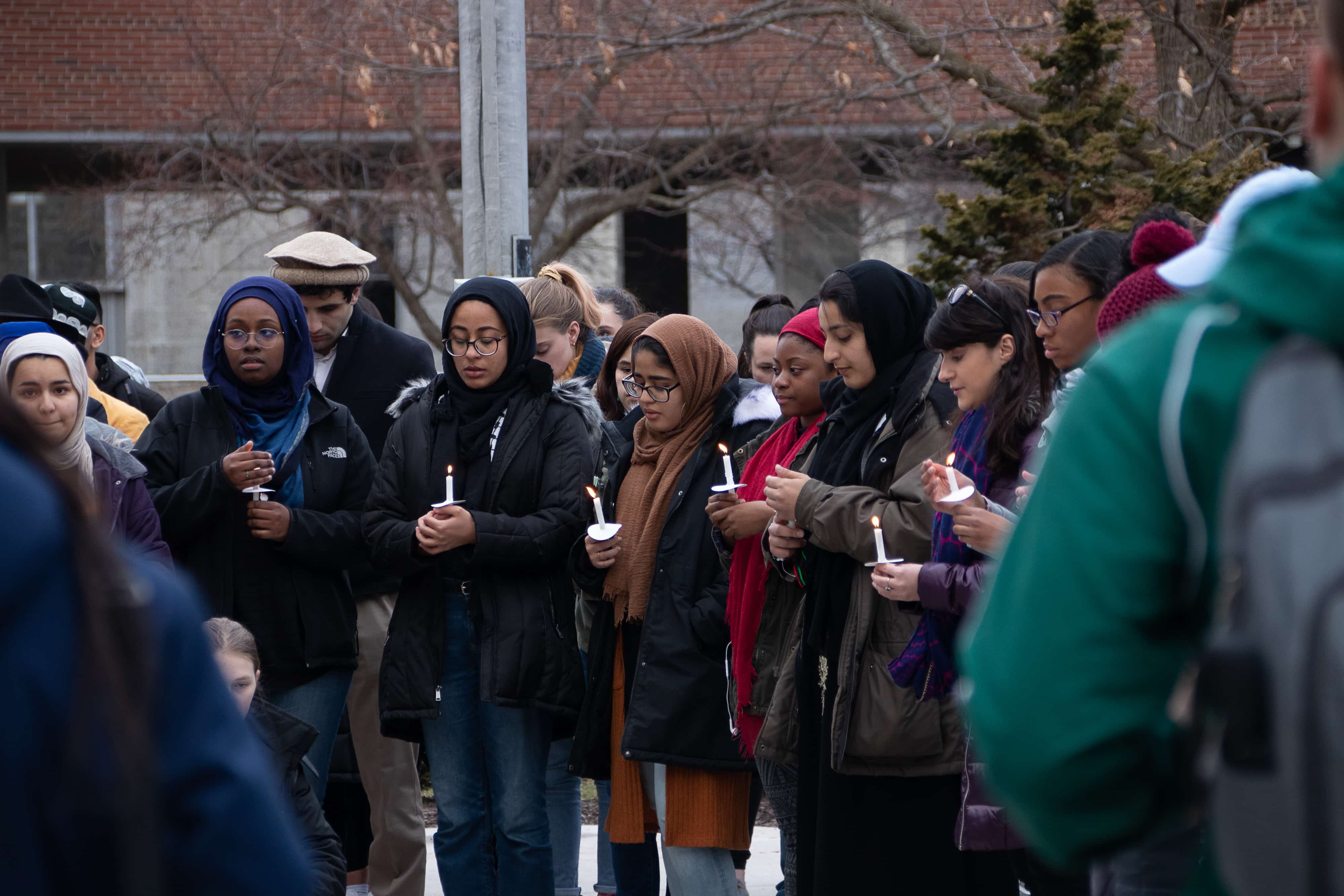 Outside Hendricks Chapel on Tuesday, Syracuse students take a moment of silence to remember the 50 people killed in mosque shootings in Christchurch, New Zealand.