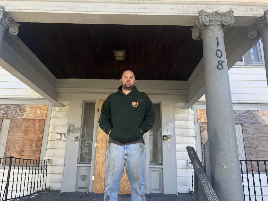 Paul Finch stands on the porch of the house at 108 Onondaga Avenue that he is restoring in spring 2019.