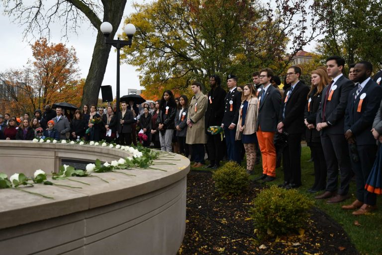 Remembrance Scholars honor the 35 SU students lost during a rose-laying ceremony on Friday.