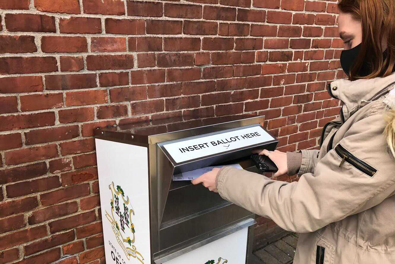 Anne Hayes submits her 2020 election ballot in Connecticut.