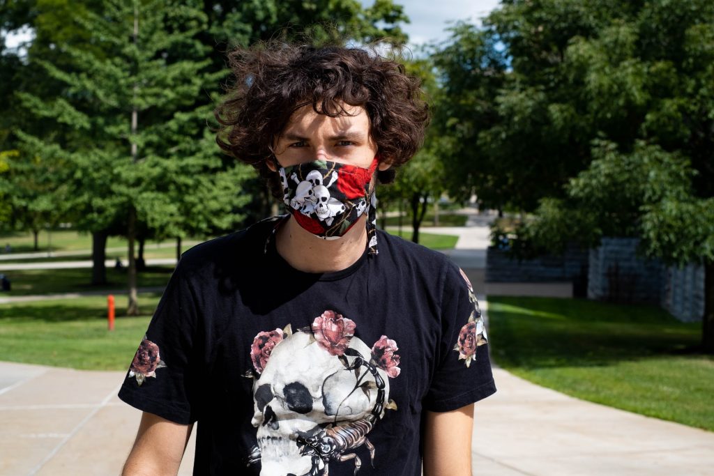 For engineering & computer science sophomore Griffin Maffioli, wearing a mask is just another way to accessorize. "It's just about finding something that matches what you already like to wear. It's just adding one more piece of cloth to your outfit." Photo by Kennedy Smith.