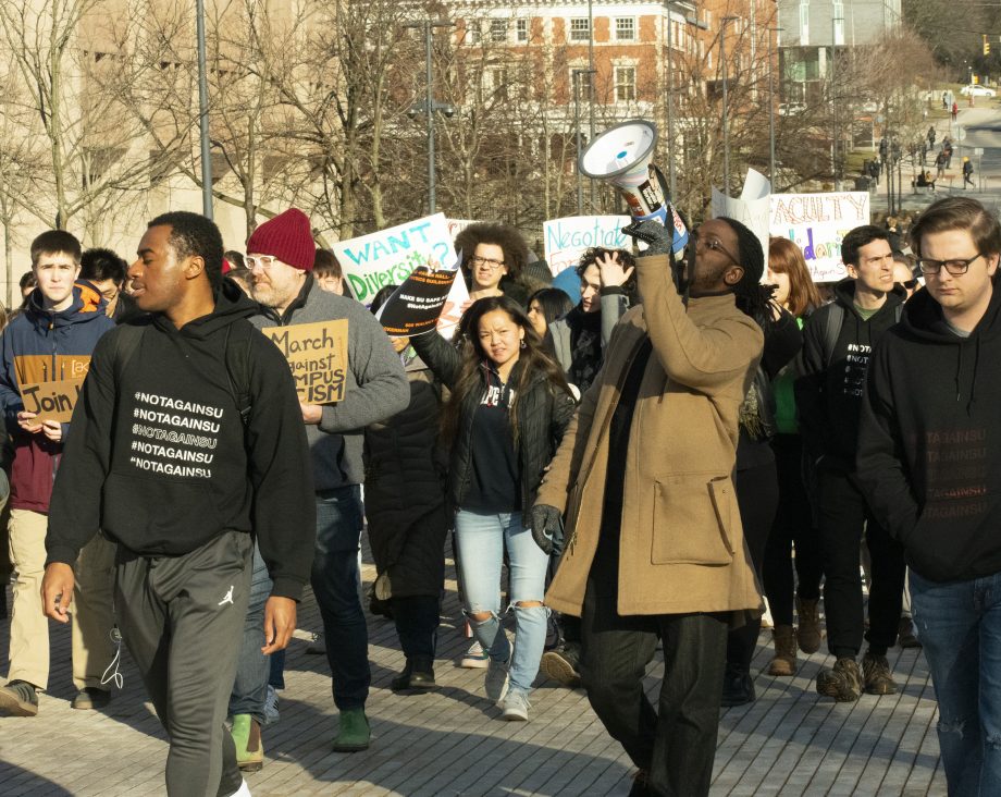 Syracuse University faculty members and students marched across campus to show solidarity with #NotAgainSU protestors on March 5, 2020.