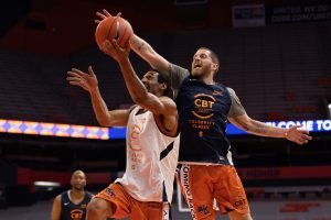 Eric Devendorf, right, comes soaring in from behind to block Lawrence Moten's layup attempt during the 2021 Coming Back Together (CBT) Celebrity Classic, Thursday, at the Carrier Dome.